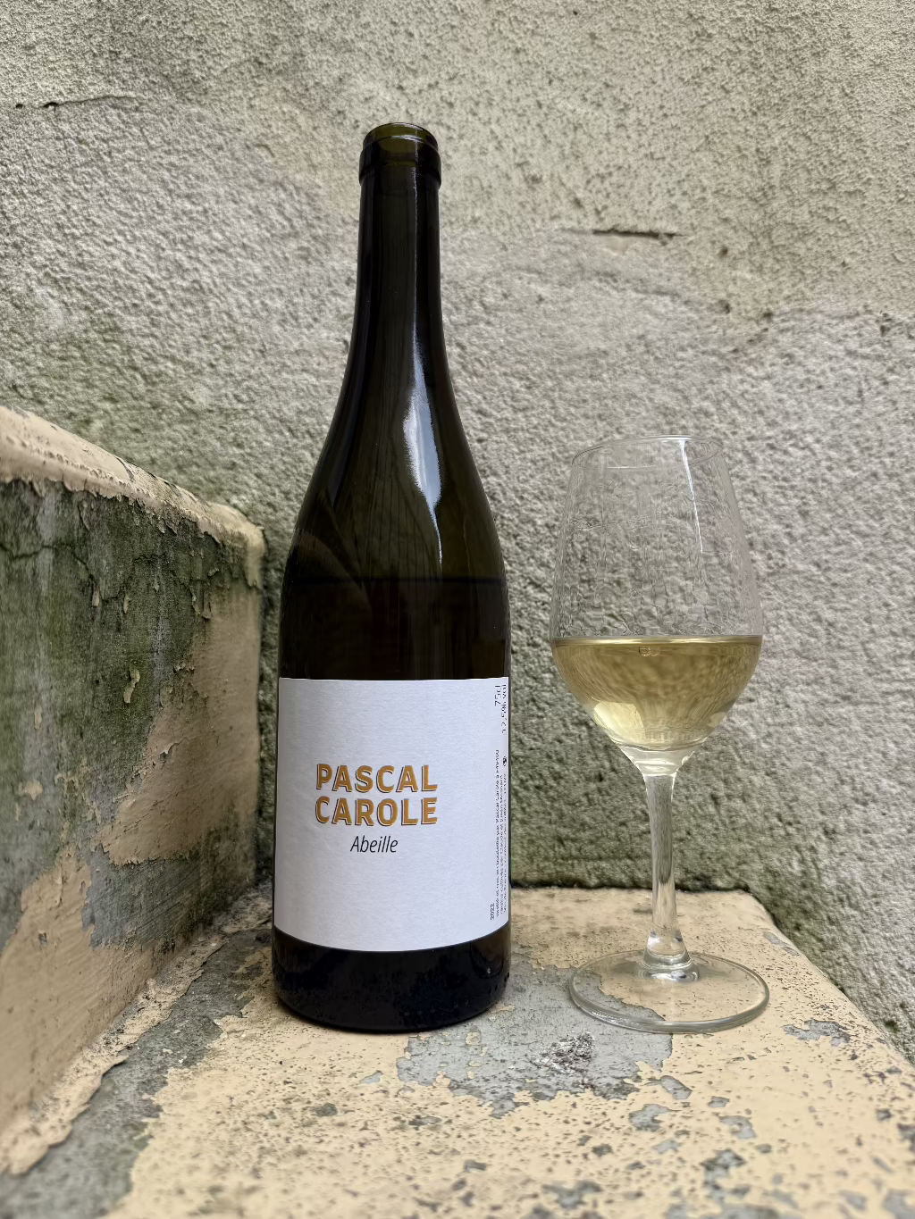 Bottle of Abeille wine next to a full glass